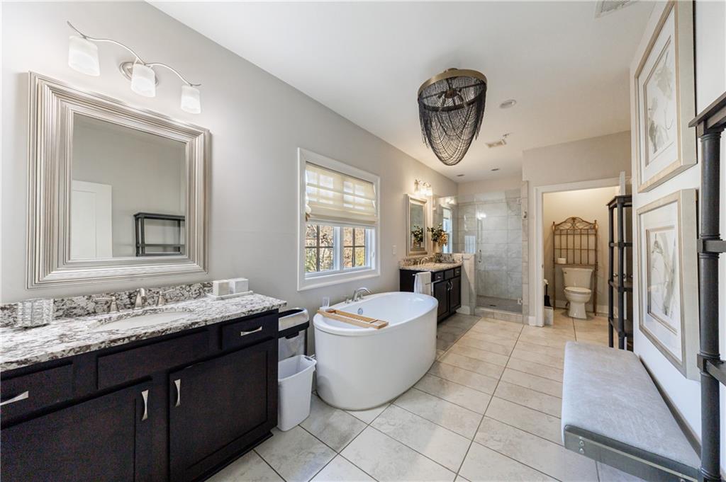 2067 Wheaton Way Atlanta, GA 30328 - Photo 43 of 64 a spacious bathroom with a granite countertop sink and a mirror