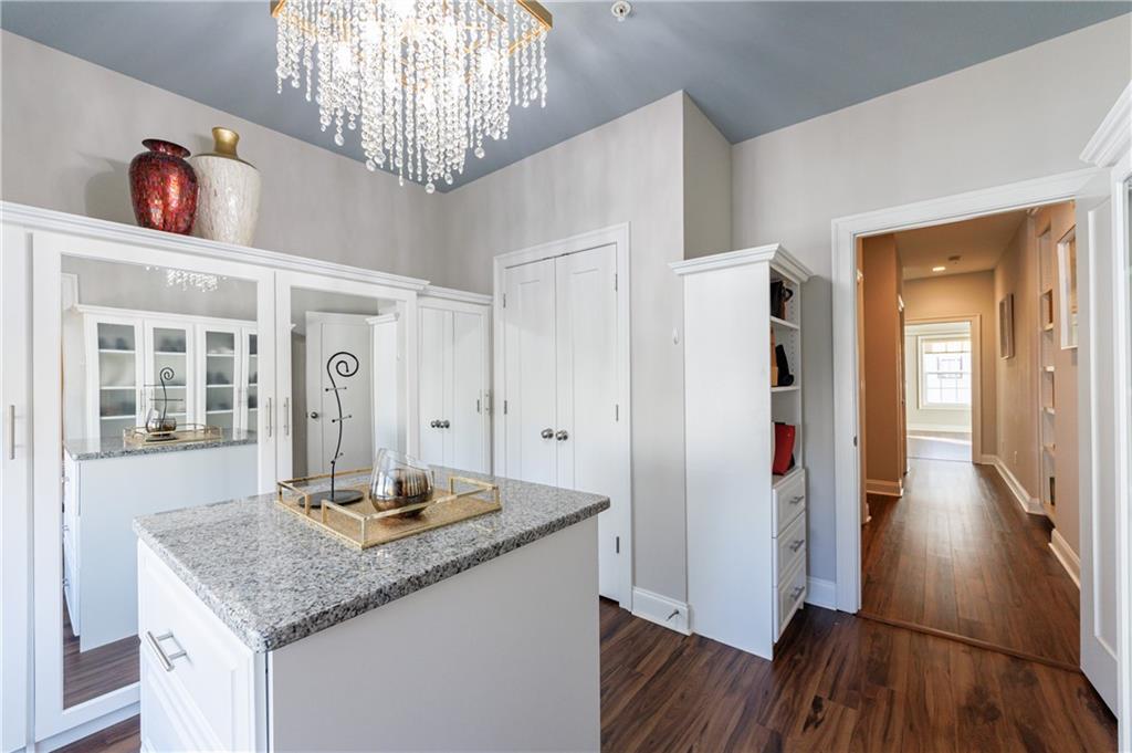 2067 Wheaton Way Atlanta, GA 30328 - Photo 45 of 64 a kitchen with stainless steel appliances granite countertop a refrigerator and a wooden floor