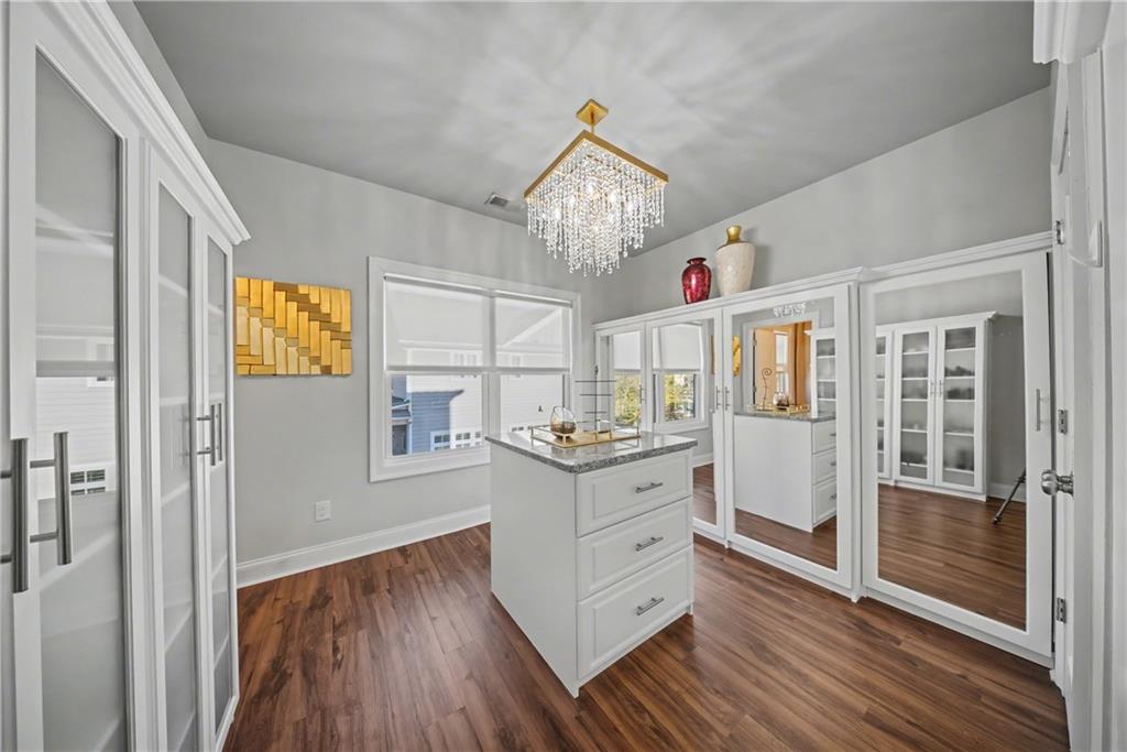 2067 Wheaton Way Atlanta, GA 30328 - Photo 48 of 64 a very nice looking room with wooden floor and chandelier