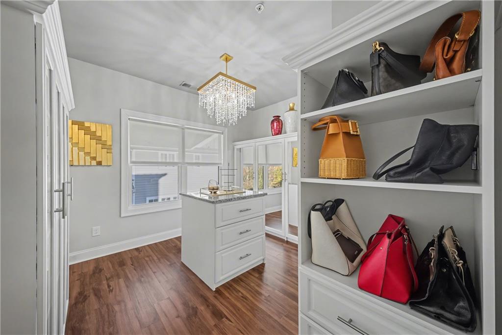 2067 Wheaton Way Atlanta, GA 30328 - Photo 49 of 64 a view of walk in closet with clothes and shoes