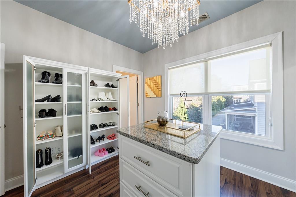 2067 Wheaton Way Atlanta, GA 30328 - Photo 50 of 64 a kitchen with granite countertop a large window and a white cabinets