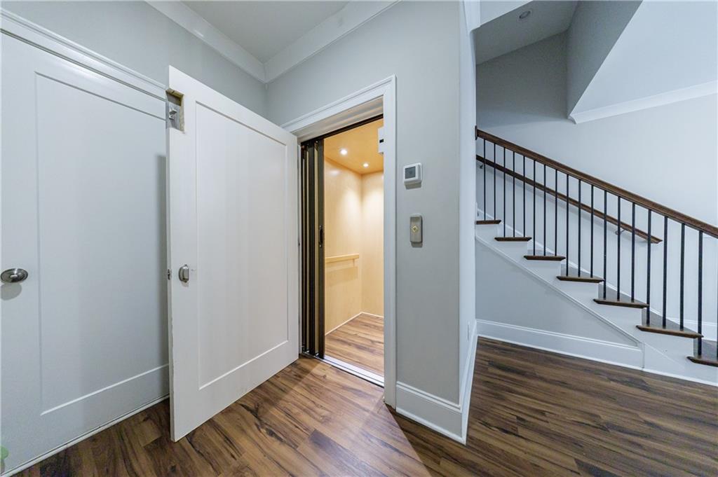 2067 Wheaton Way Atlanta, GA 30328 - Photo 6 of 64 a view of a hallway with wooden floor and entryway