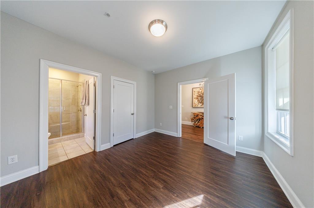 2067 Wheaton Way Atlanta, GA 30328 - Photo 7 of 64 an empty room with wooden floor and windows