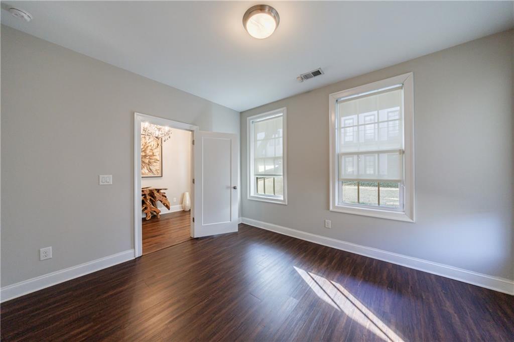 2067 Wheaton Way Atlanta, GA 30328 - Photo 8 of 64 an empty room with wooden floor and windows