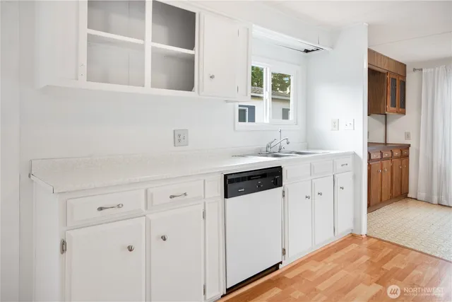 a kitchen with cabinets and window