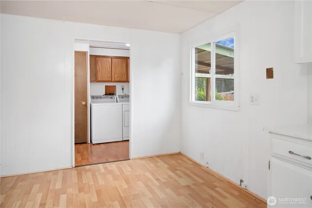 an empty room with windows and cabinet