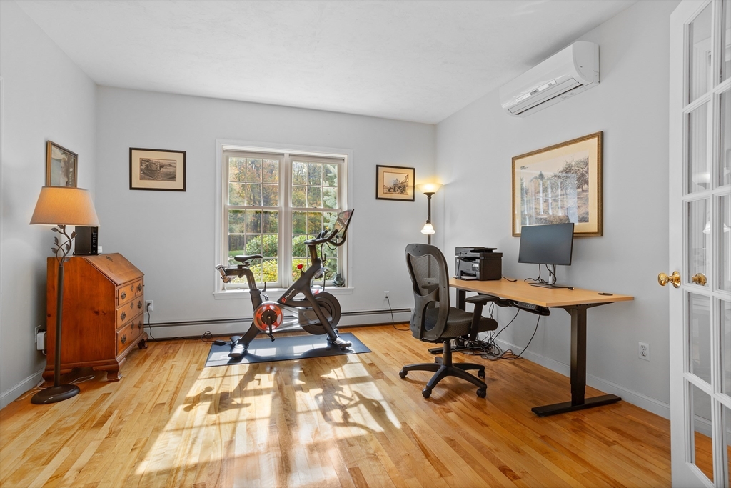 104 Green Road Bolton, MA 01740 - Photo 19 of 42 a view of a workspace with furniture and a window