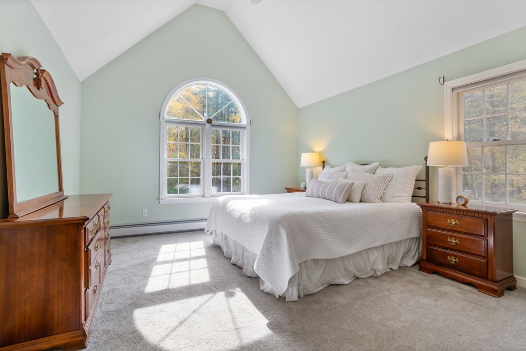 104 Green Road Bolton, MA 01740 - Photo 23 of 42 a spacious bedroom with a bed and a dresser next to a window
