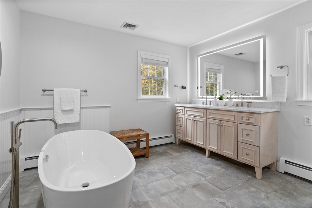 104 Green Road Bolton, MA 01740 - Photo 25 of 42 a bathroom with a double vanity sink mirror and toilet