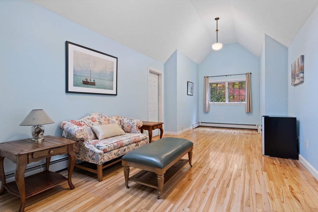 104 Green Road Bolton, MA 01740 - Photo 30 of 42 a living room with furniture and a wooden floor