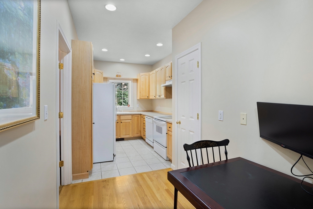 104 Green Road Bolton, MA 01740 - Photo 32 of 42 a kitchen with a table chairs refrigerator and a sink