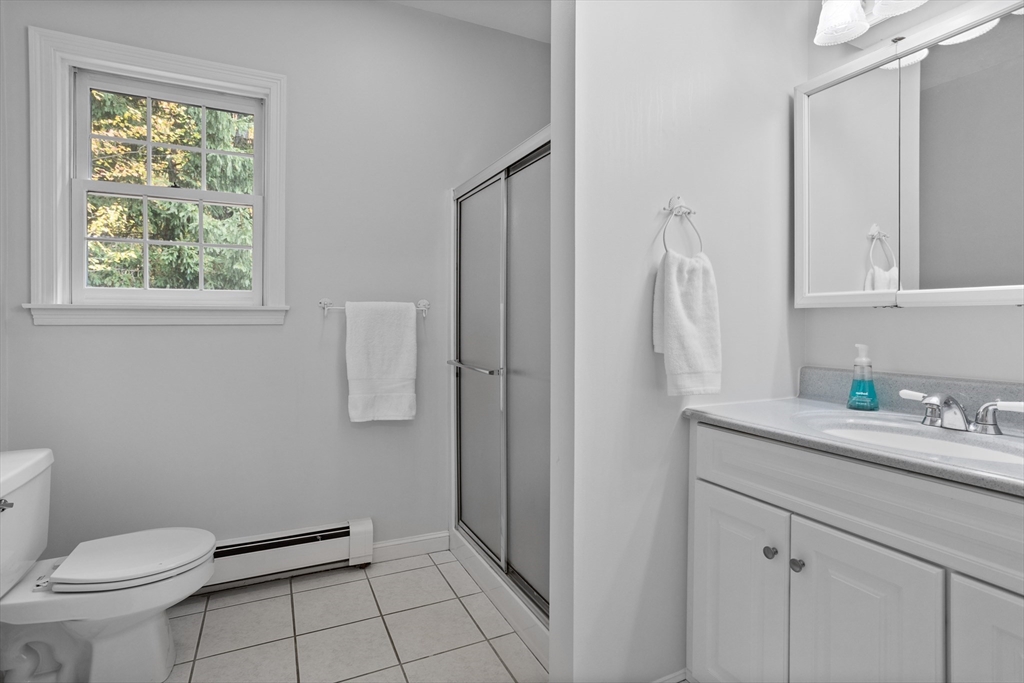 104 Green Road Bolton, MA 01740 - Photo 35 of 42 a bathroom with a granite countertop toilet sink and mirror