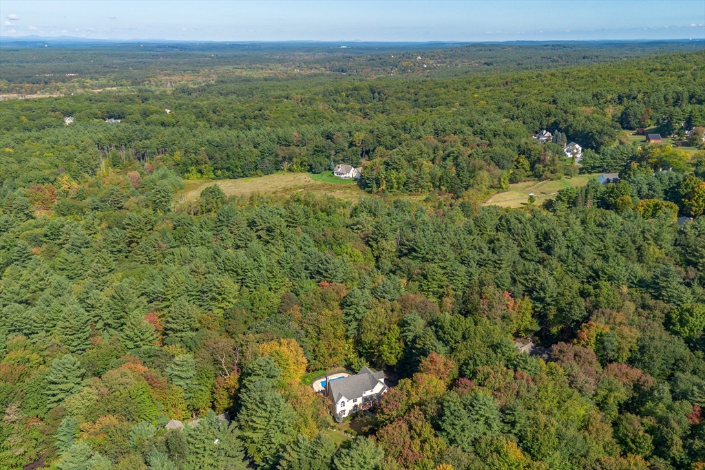 104 Green Road Bolton, MA 01740 - Photo 42 of 42 a view of a city with lush green forest