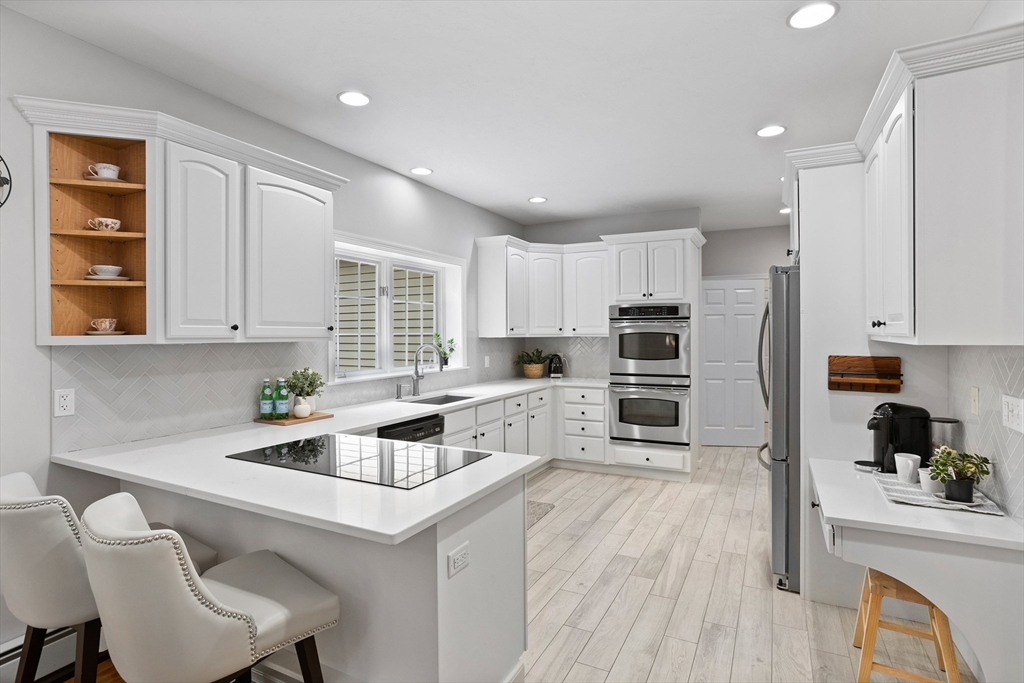 104 Green Road Bolton, MA 01740 - Photo 6 of 42 a kitchen with white cabinets and stainless steel appliances