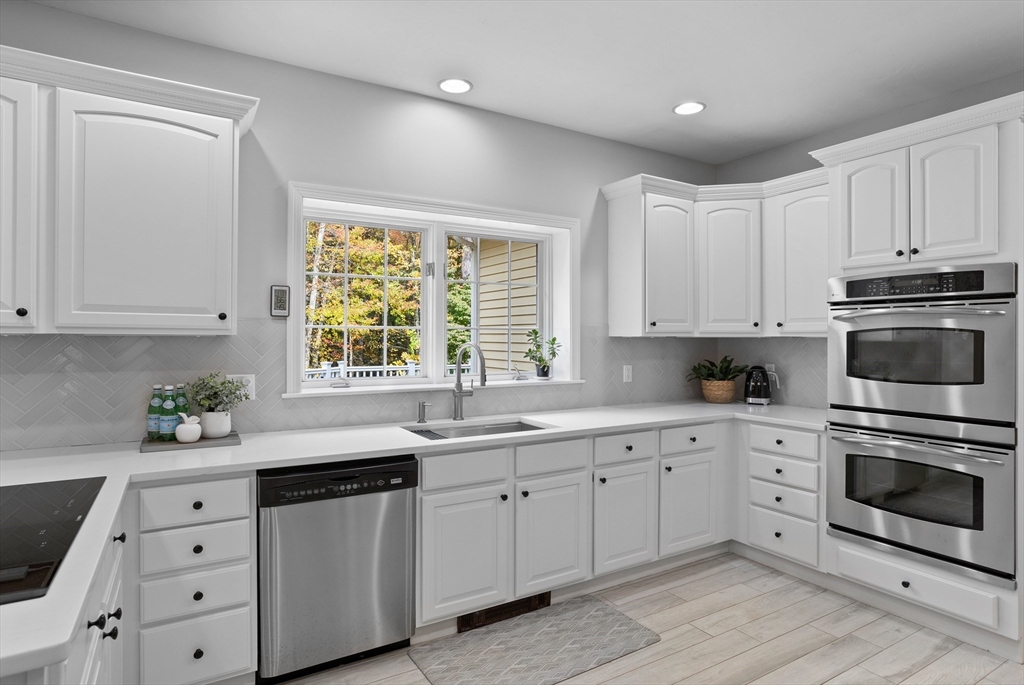104 Green Road Bolton, MA 01740 - Photo 7 of 42 a kitchen with white cabinets sink and window