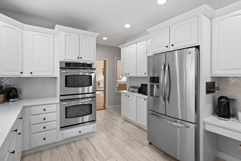 104 Green Road Bolton, MA 01740 - Photo 8 of 42 a kitchen with cabinets stainless steel appliances and wooden floor