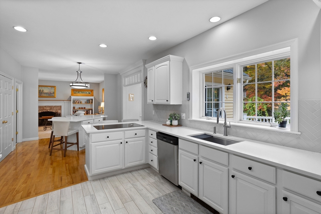 104 Green Road Bolton, MA 01740 - Photo 9 of 42 a open kitchen with sink cabinets and wooden floor