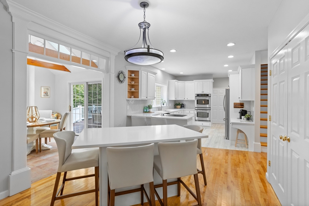 104 Green Road Bolton, MA 01740 - Photo 10 of 42 a large kitchen with a table and chairs