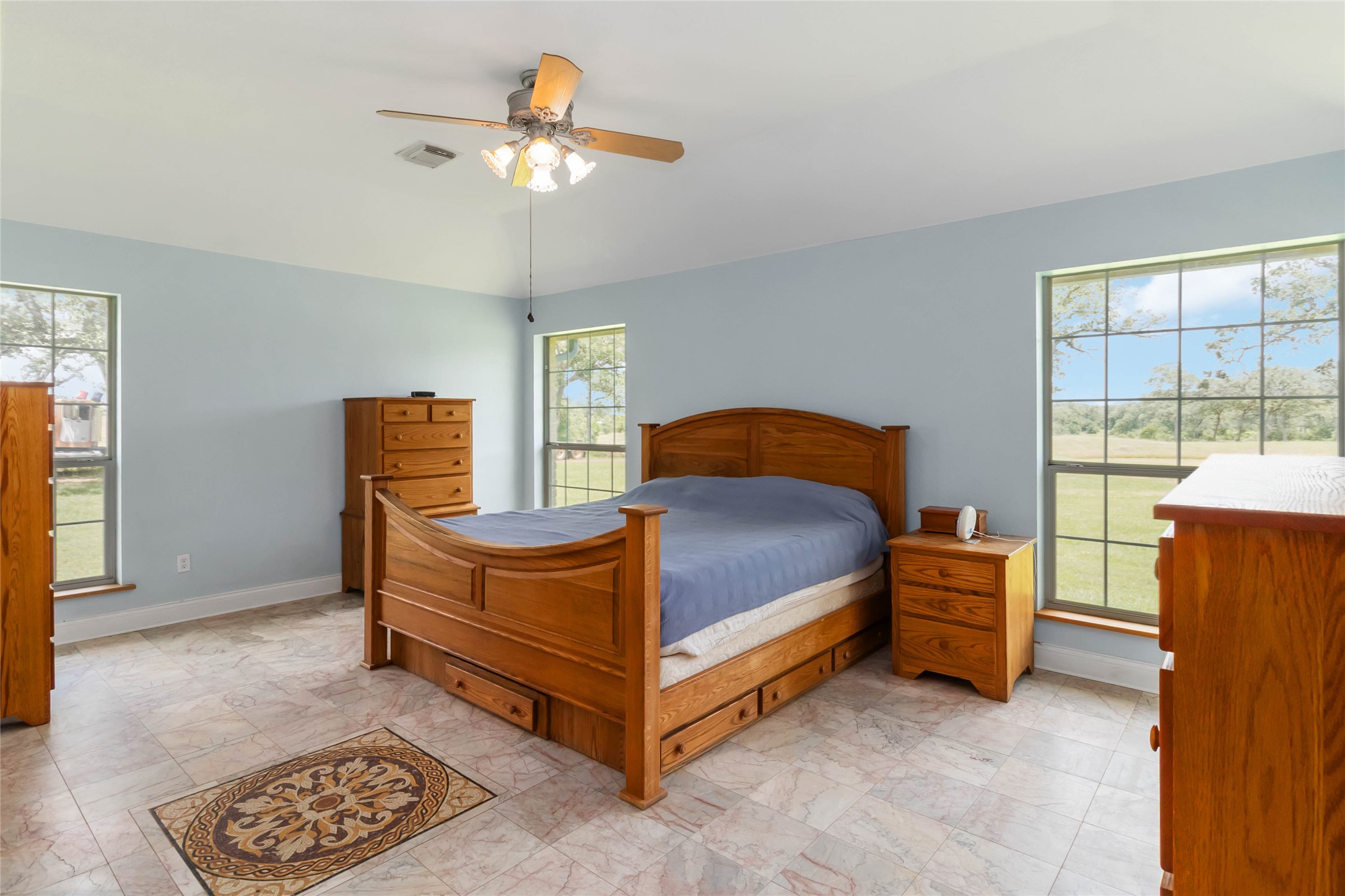 1208 Jeddo Road Rosanky, TX 78953 - Photo 11 of 40 A tranquil bedroom with high ceilings and generous windows offers peaceful outdoor views.