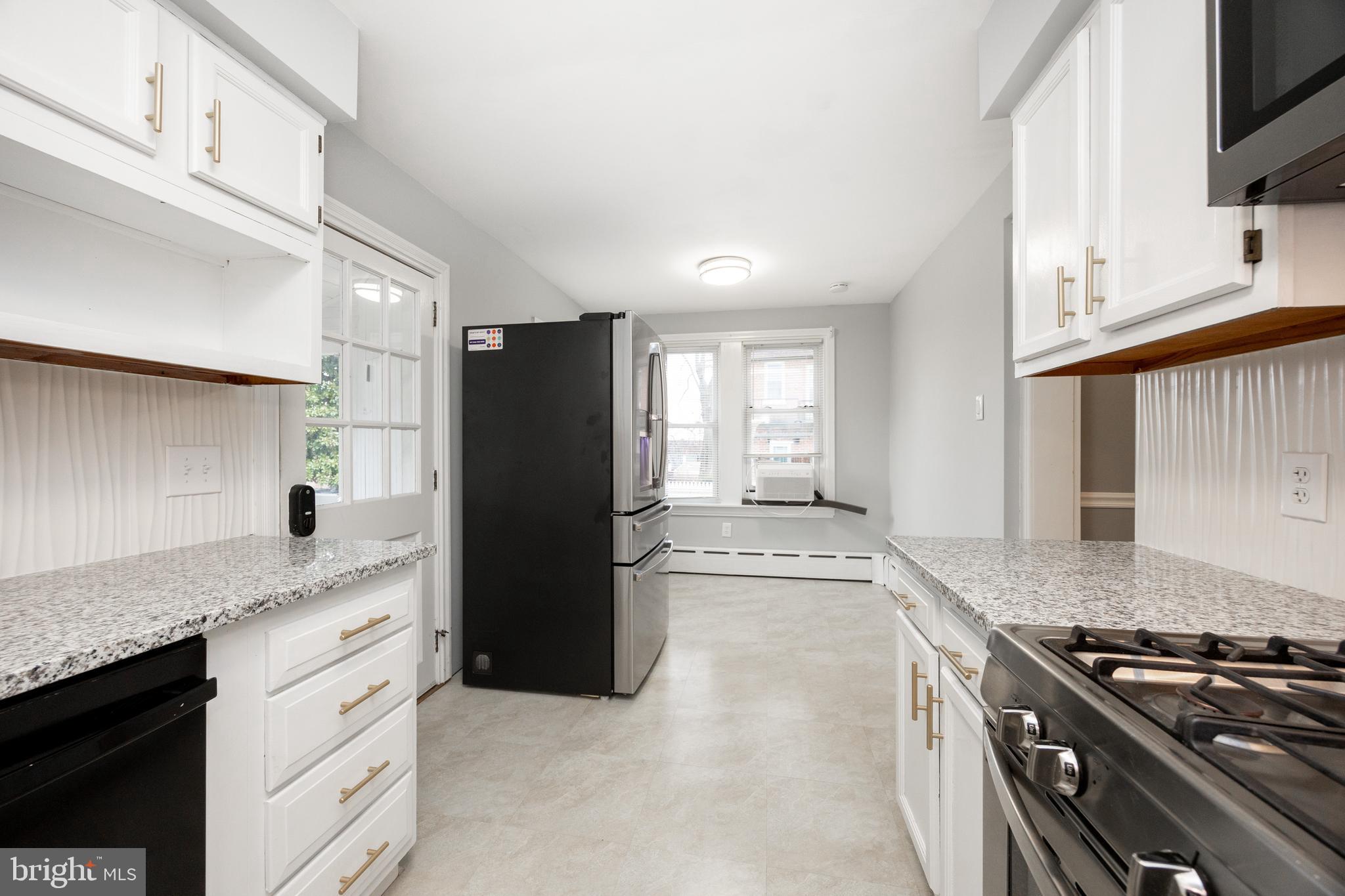 313 Chestnut Street Spring City, PA 19475 - Photo 12 of 38 a kitchen with granite countertop a refrigerator stove and sink