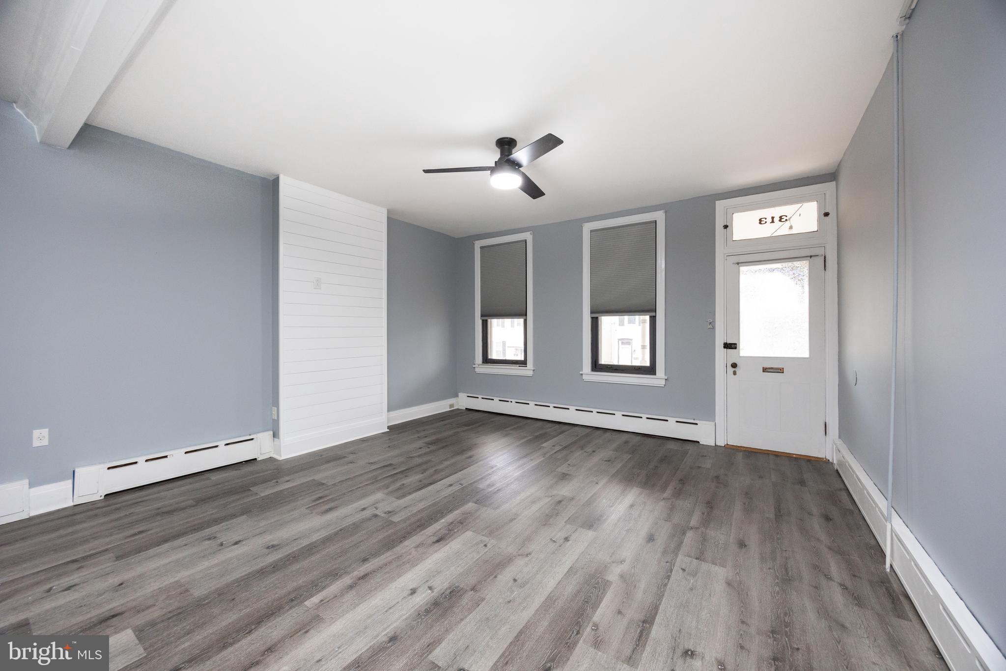 313 Chestnut Street Spring City, PA 19475 - Photo 21 of 38 a view of an empty room with window and wooden floor