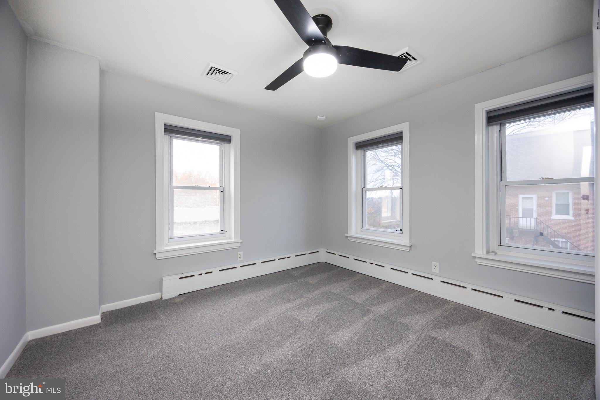 313 Chestnut Street Spring City, PA 19475 - Photo 22 of 38 an empty room with chandelier fan and windows