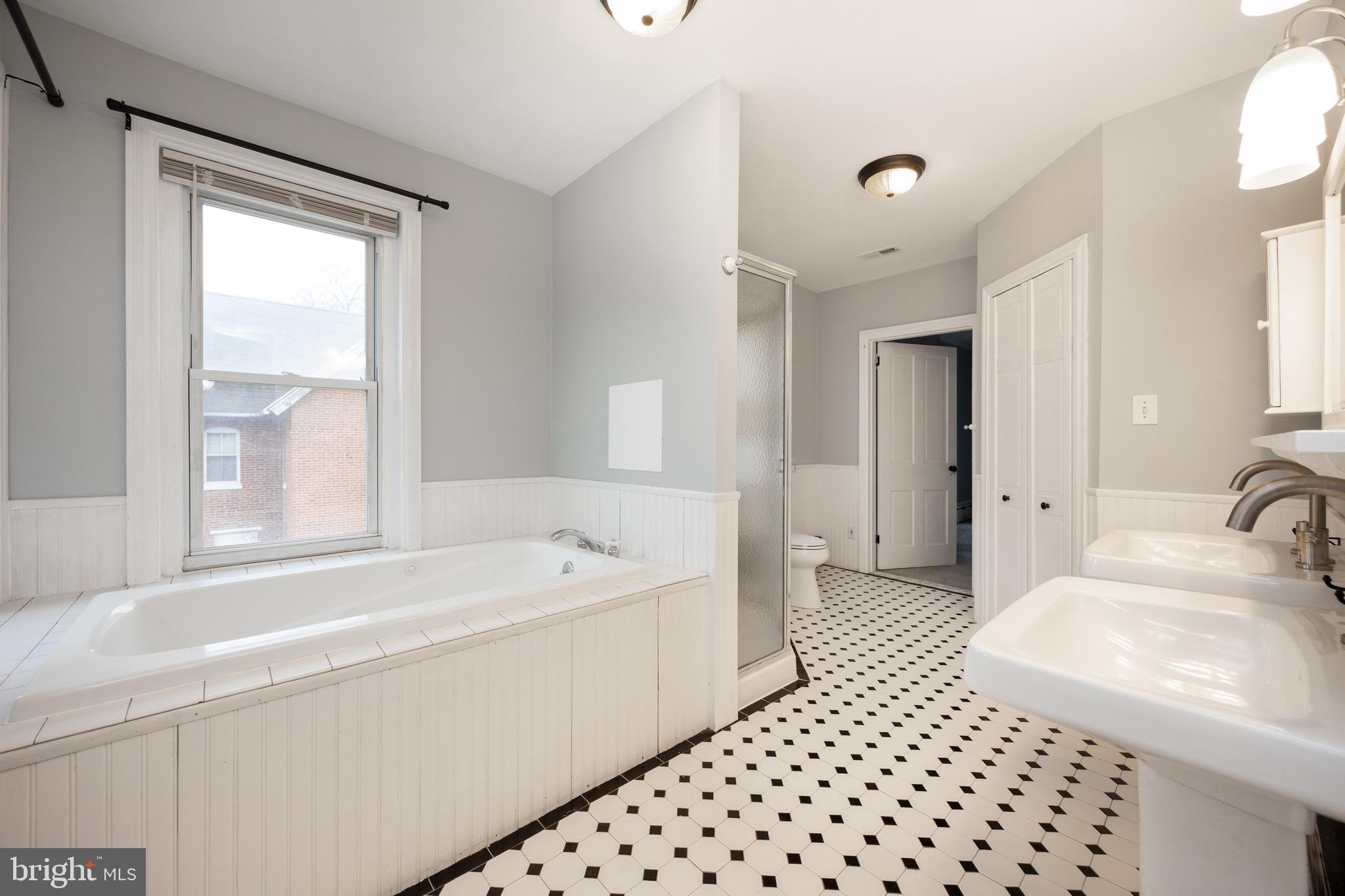 313 Chestnut Street Spring City, PA 19475 - Photo 25 of 38 a bathroom with a bathtub sink vanity and a shower