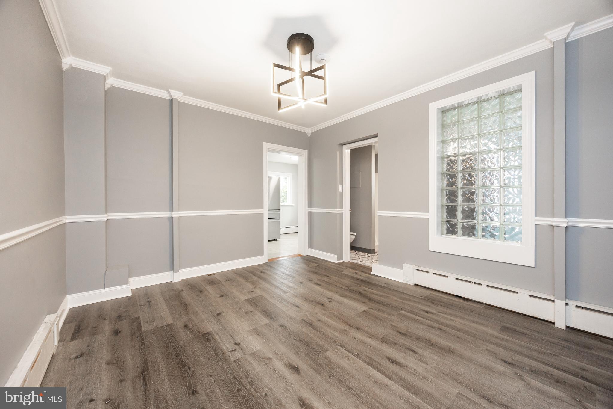 313 Chestnut Street Spring City, PA 19475 - Photo 9 of 38 a view of an empty room with a window and wooden floor