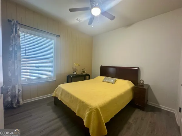 a bed sitting in a bedroom next to a window