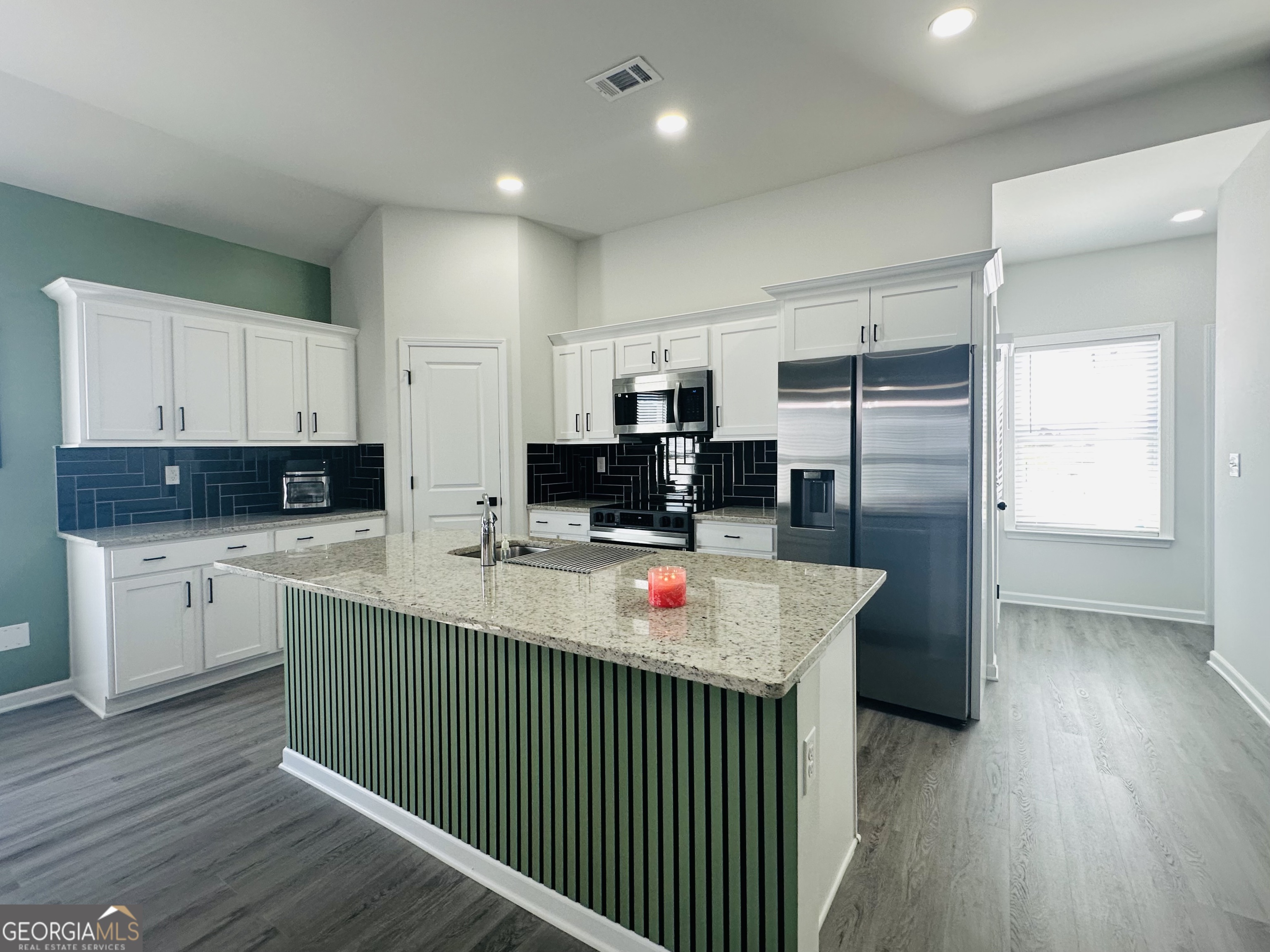 604 Georgian Walk Byron, GA 31008 - Photo 8 of 15 a kitchen that has a lot of cabinets and wooden floor