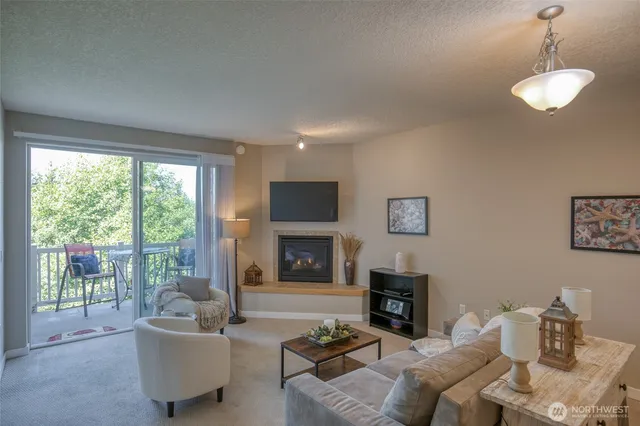 a living room with furniture a fireplace and a flat screen tv