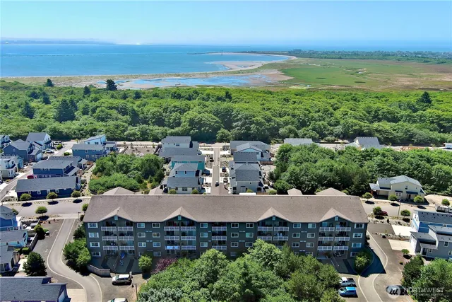 an aerial view of a house with garden space and ocean view