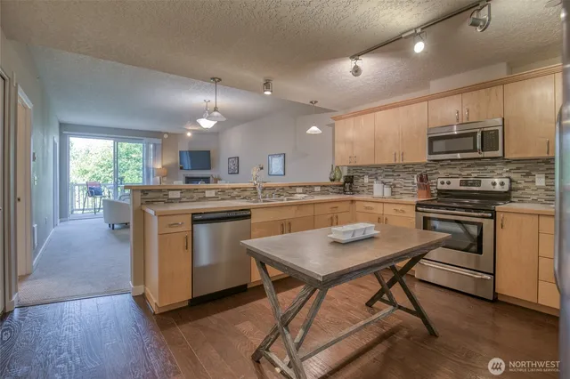 a kitchen with a stove a sink and a refrigerator