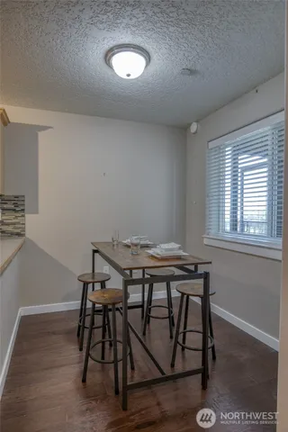 a view of a workspace with furniture and wooden floor