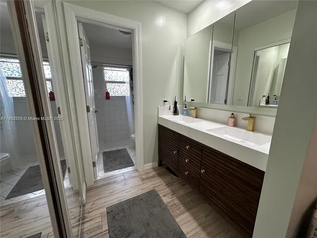 a bathroom with a double vanity sink and mirror