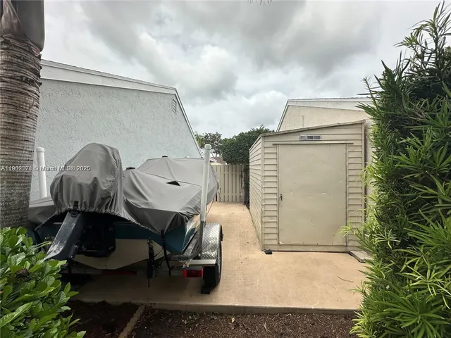 a view of a chairs and table in backyard