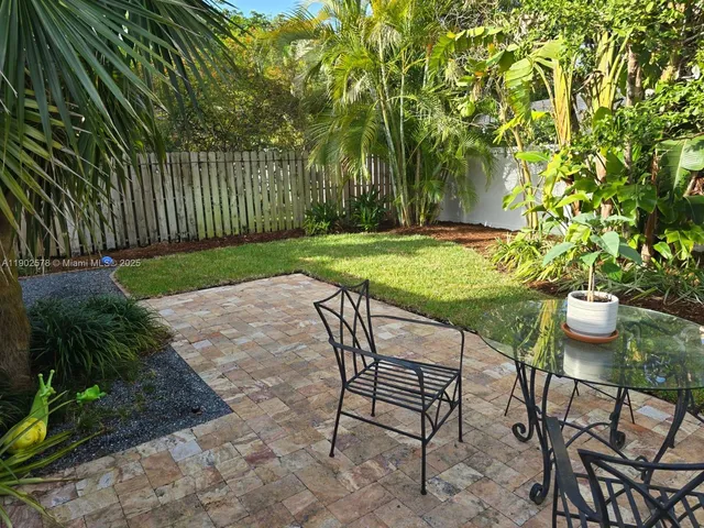 a view of a backyard with large trees