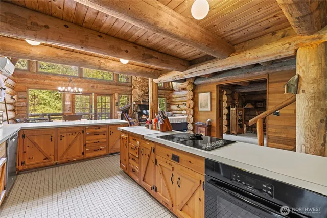 a kitchen with sink a stove and cabinets