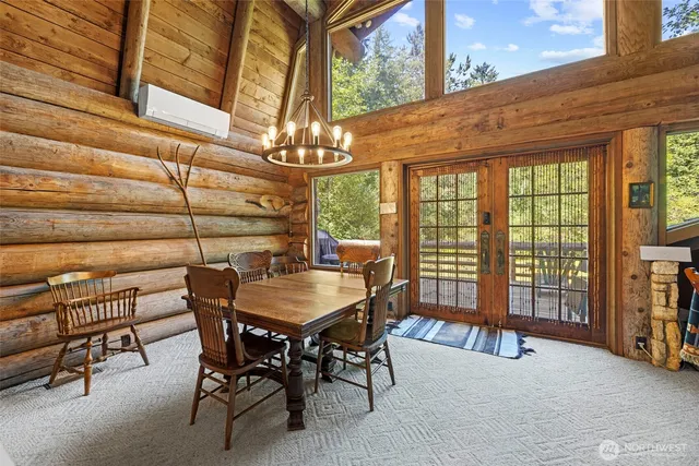 a dining room with furniture a chandelier and a rug