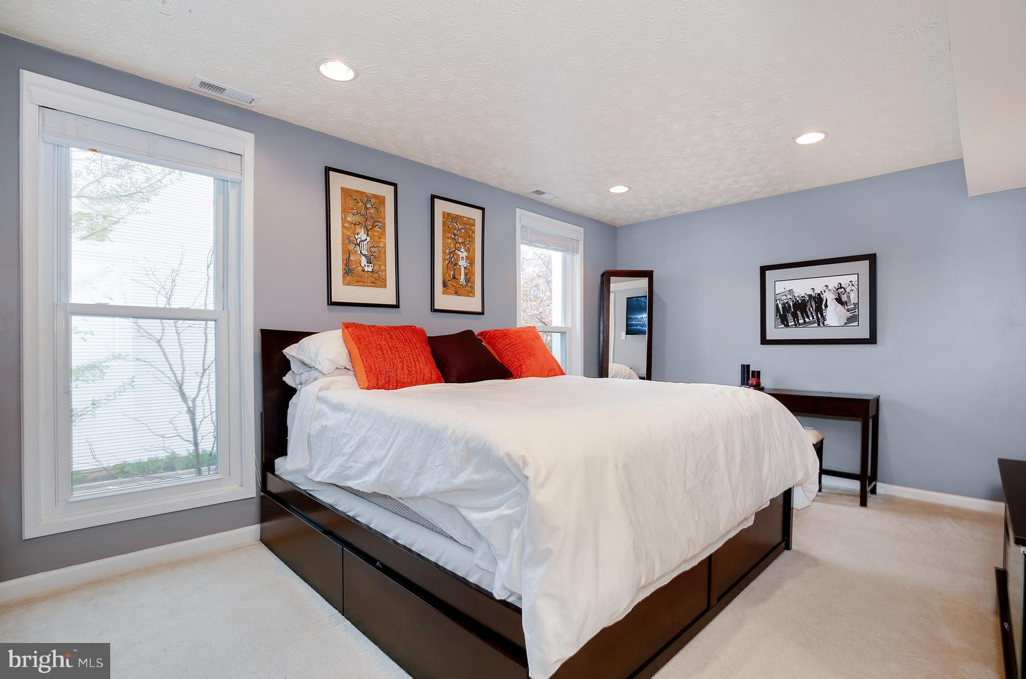 1119 Harvard Street Northwest, Unit R Washington, DC 20009 - Photo 17 of 26 a bedroom with a large bed and a window