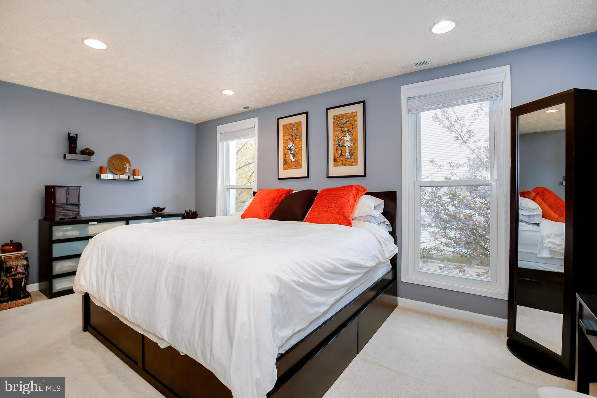 1119 Harvard Street Northwest, Unit R Washington, DC 20009 - Photo 18 of 26 a bed sitting in a bedroom next to a window