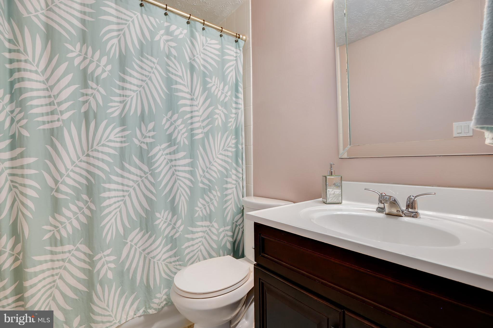 1119 Harvard Street Northwest, Unit R Washington, DC 20009 - Photo 20 of 26 a bathroom with a sink a toilet and a mirror