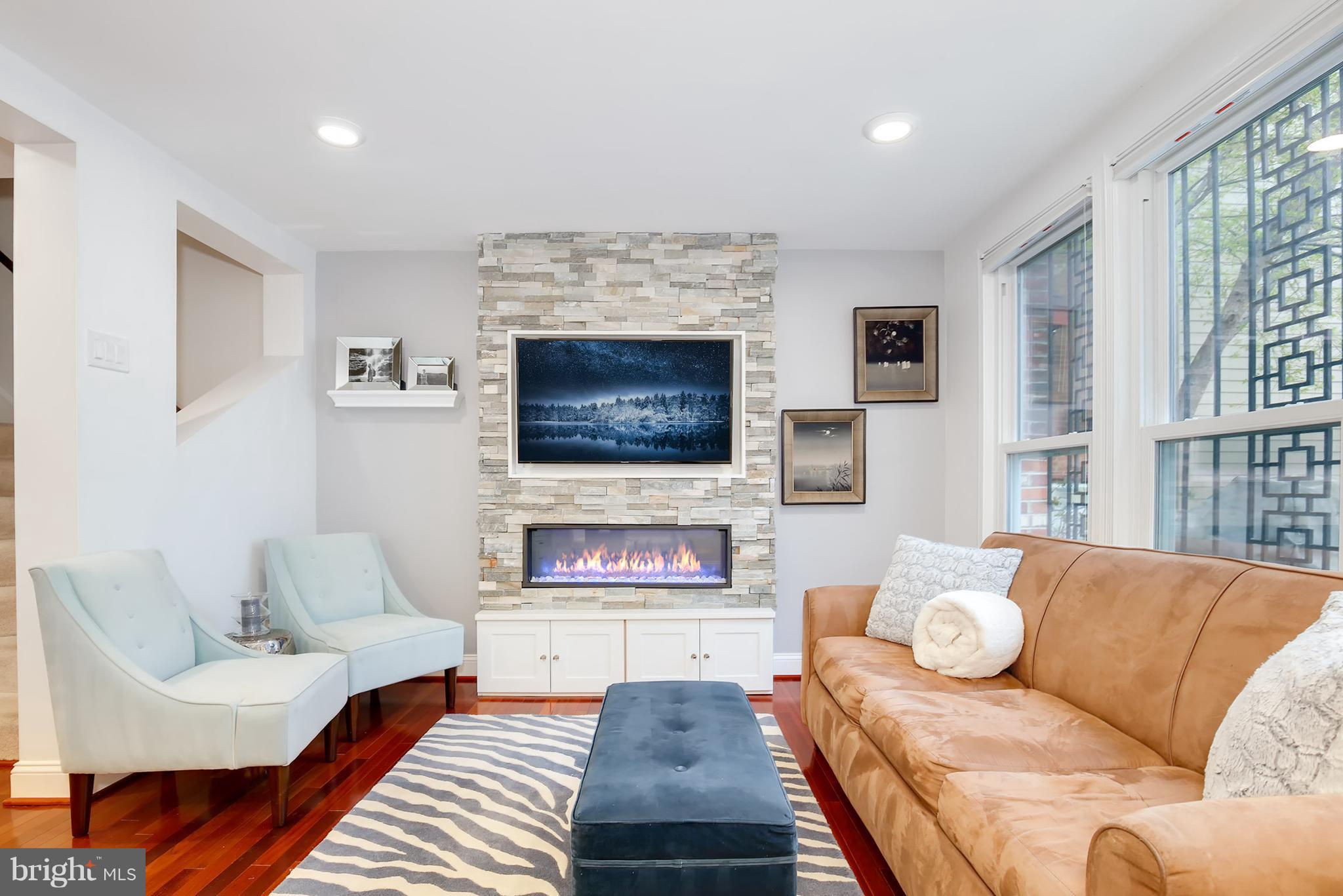 1119 Harvard Street Northwest, Unit R Washington, DC 20009 - Photo 3 of 26 a living room with furniture and a flat screen tv