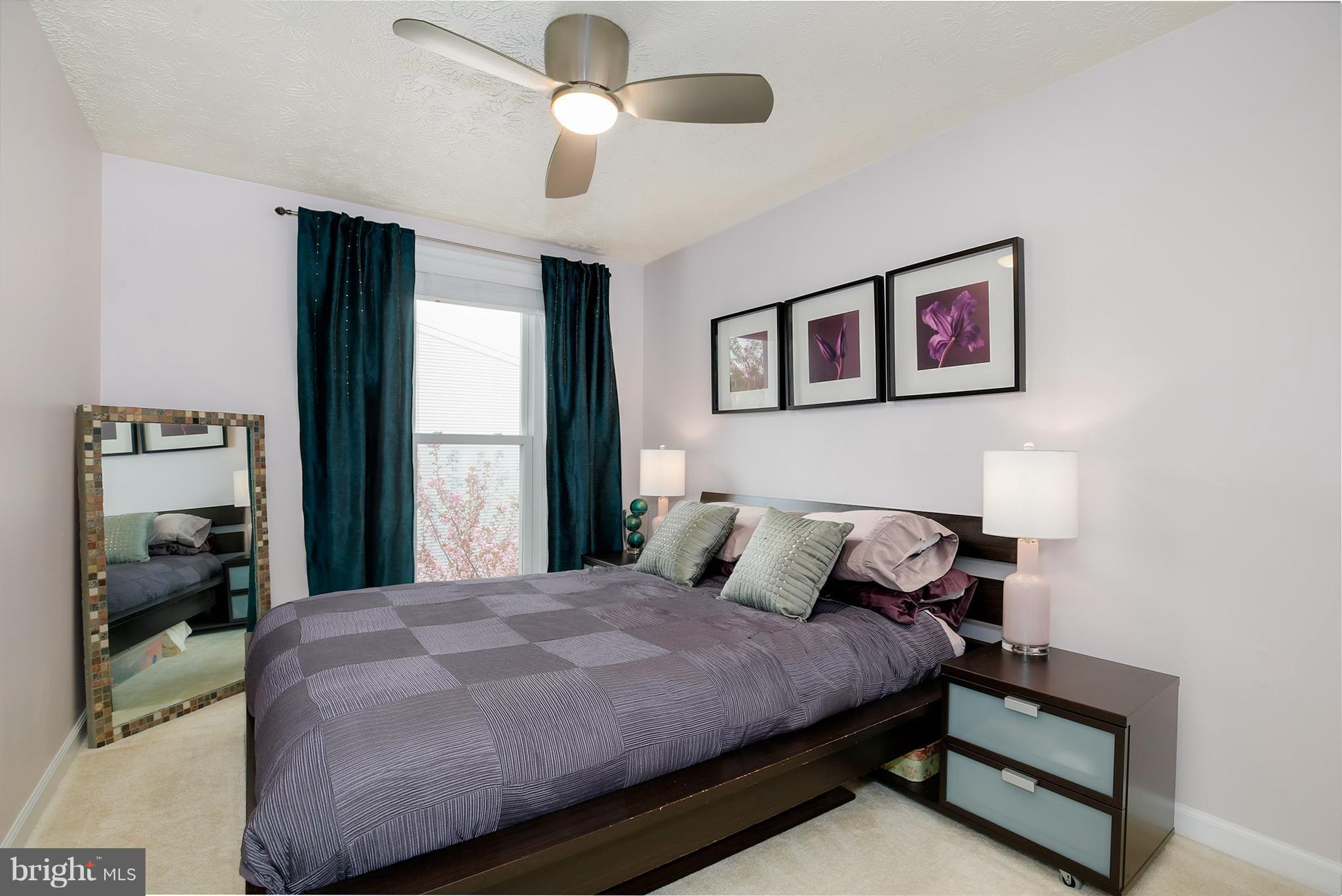 1119 Harvard Street Northwest, Unit R Washington, DC 20009 - Photo 21 of 26 a bedroom with a bed and a large mirror