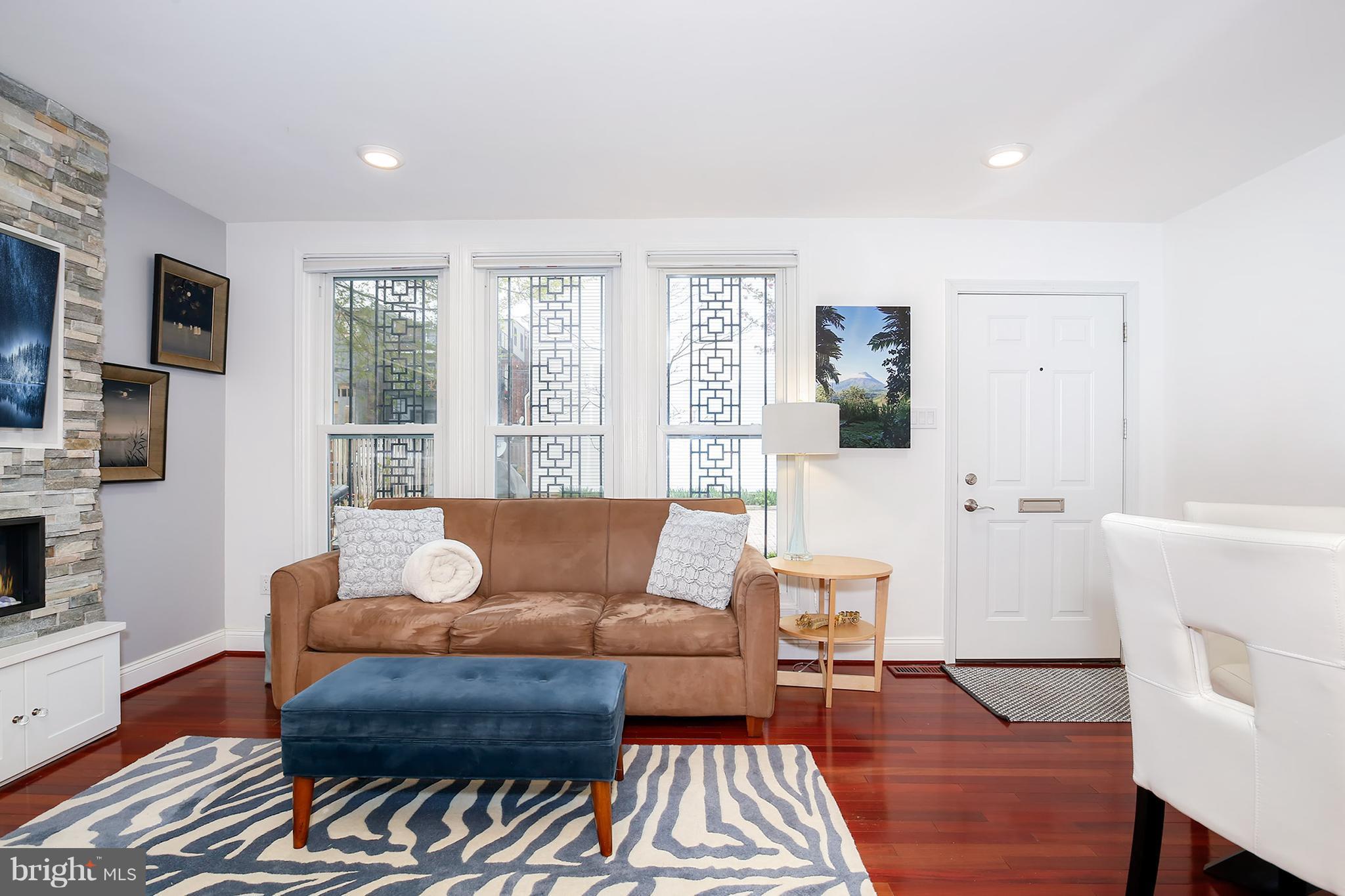 1119 Harvard Street Northwest, Unit R Washington, DC 20009 - Photo 5 of 26 a living room with furniture and a fireplace
