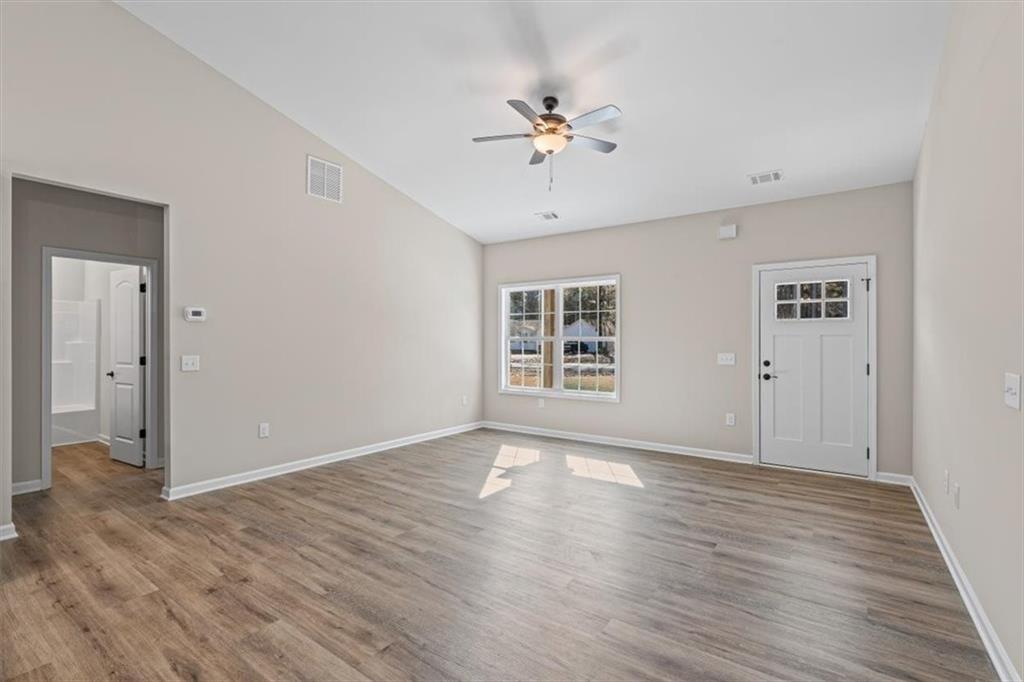 146 Old Brock Road Rockmart, GA 30153 - Photo 11 of 45 a view of an empty room with wooden floor and a window