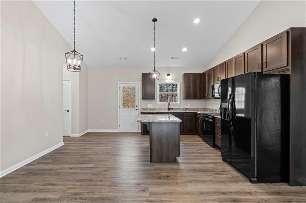 146 Old Brock Road Rockmart, GA 30153 - Photo 14 of 45 a kitchen with kitchen island a counter top space stainless steel appliances and wooden floor