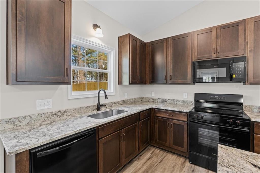 146 Old Brock Road Rockmart, GA 30153 - Photo 18 of 45 a kitchen with stainless steel appliances granite countertop a sink stove and microwave