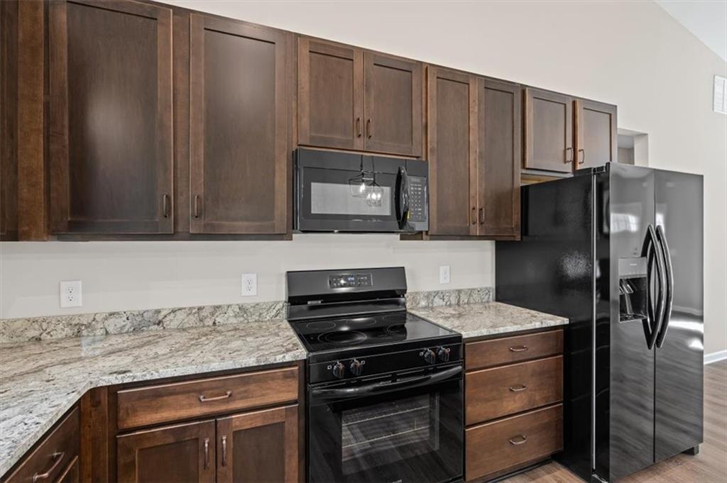 146 Old Brock Road Rockmart, GA 30153 - Photo 19 of 45 a kitchen with granite countertop a refrigerator stove and sink