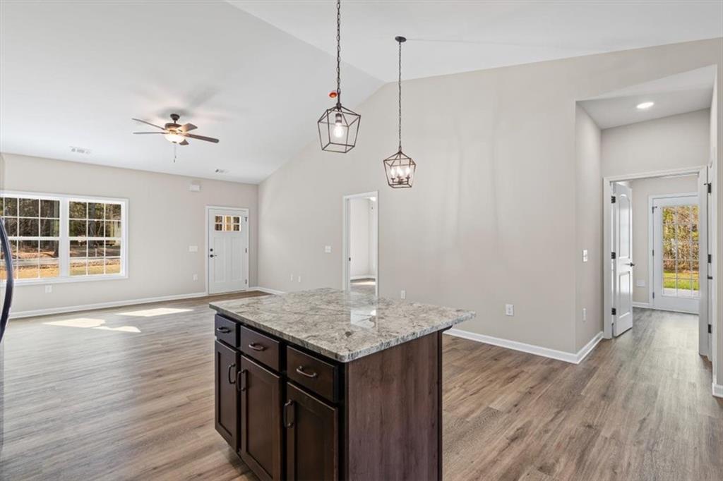 146 Old Brock Road Rockmart, GA 30153 - Photo 20 of 45 a kitchen with a wooden floor and a chandelier